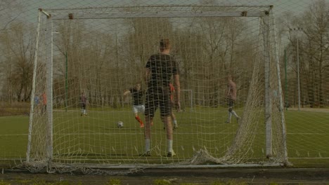 Striker-scoring-a-goal-during-training-match