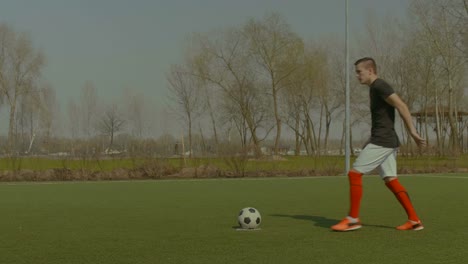 Handsome-soccer-player-taking-a-penalty-kick