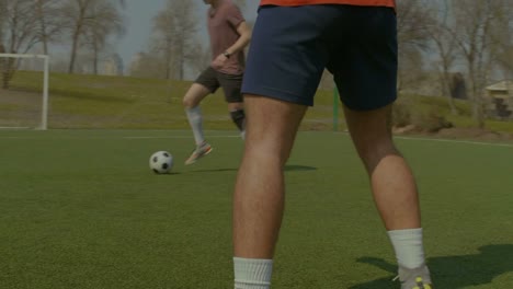 Young-soccer-players-training-football-on-the-pitch