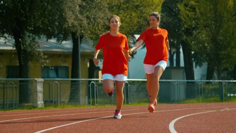 Athletes-pass-the-baton-in-a-track-relay.-shot-in-super-slow-motion