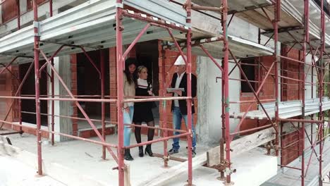 Lesbian-Couple-Buying-New-House-In-Construction-Site-With-Architect-copy