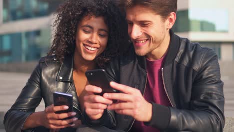 Couple-using-mobile-phones-outdoors