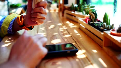 Woman-hand-using-smartphone-in--cafe-background.-Business,-financial,-trade-stock-maket-and-social-network-concept.