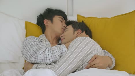 Young-asian-gay-couple-enjoy-love-moment-while-lying-on-bed-when-relaxed.-Lifestyle-LGBT-couple-together-indoors-concept.