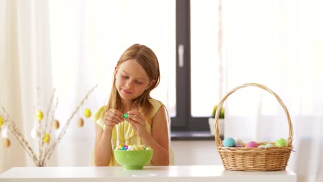 girl-removing-wrapper-of-chocolate-easter-egg