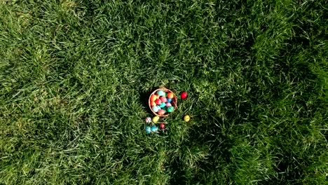 colorful-easter-eggs-in-the-fresh-spring-meadow,-aerial-view