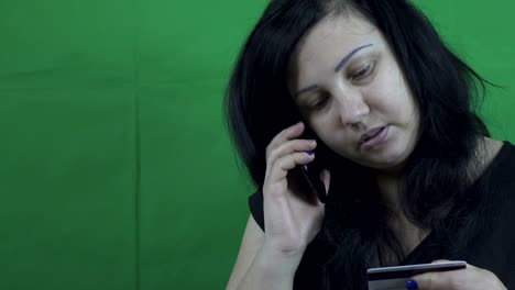 Woman-talking-on-the-phone-with-online-payment-support.-Smartphone-and-credit-card