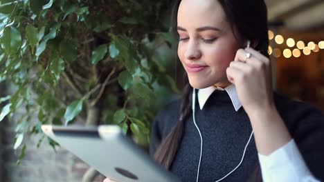 young-Girl-Listening-Music-on-Tablet