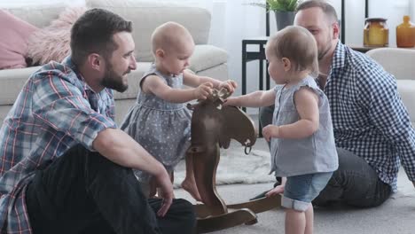 Fathers-and-baby-girls-playing-with-rocking-deer