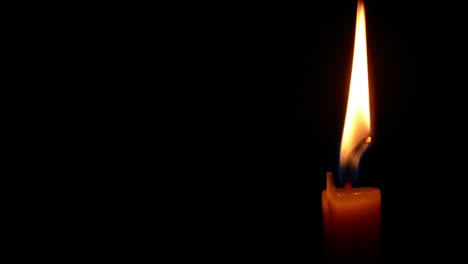 Simple-burning-candle-close-up-on-a-black-background.-full-HD-1920-X-1080