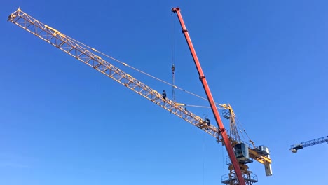 Worker-installing-jib-on-a-building-crane