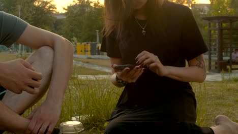 Young-woman-with-mobile-phone-in-the-park