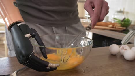 Disabled-Man-with-Bionic-Arm-Whipping-Eggs-in-Glass-Bowl