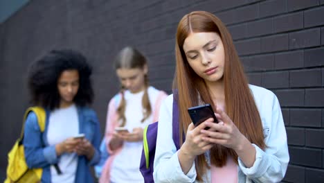 Süchtige-weibliche-Teenager-lesen-Kommentare-in-sozialen-Netzwerken-mit-Smartphones