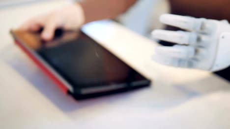 Artificial-arm-is-holding-a-tablet-computer