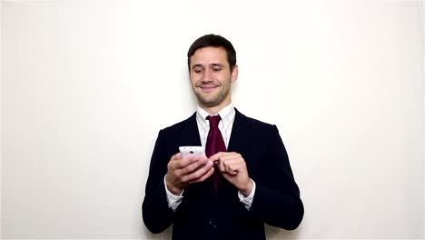 Young-handsome-businessman-is-viewing-a-news-feed-on-his-smartphone.