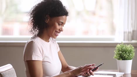 Smiling-african-american-woman-using-smartphone-dating-app-swiping