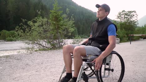 Slowmotion-of-disabled-young-student-man-in-a-wheelchair-observing-nature-around-him