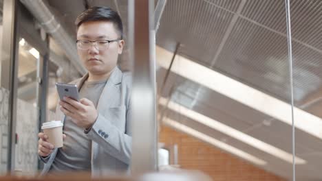 Young-Asian-Businessman-on-Coffee-Break