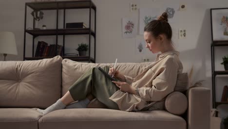 Artist-Painting-Plant-at-Workplace-or-Woman-Using-Tablet-and-Pencil-for-Artwork