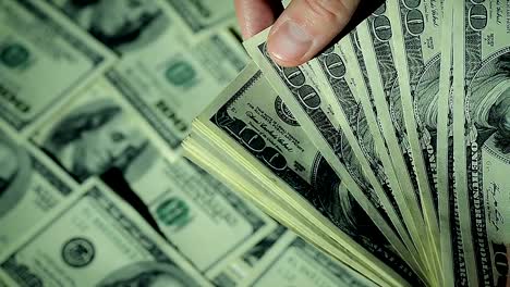 Close-Up-Man-is-Counting-His-Money.100'-Banknotes