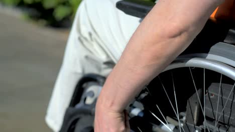 Close-up-of-disabled-man-using-wheelchair