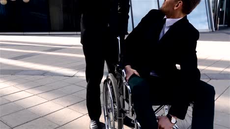 Happy-disabled-businessman,-spending-time-in-business-district-with-his-friend