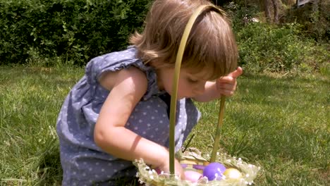 Beautiful-little-innocent-girl-looking-through-her-Easter-basket-in-slow-motion