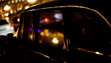 Retro-car-parked-on-Republic-Square-at-night,-reflection-of-Post-Office-Building