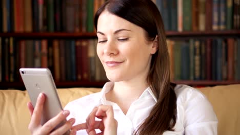 Businesswoman-at-home-using-mobile.-Young-female-professional-having-conversation-on-smartphone