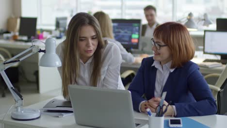 Paraplegic-Businesswoman-Speaking-with-Female-Colleague-in-Office