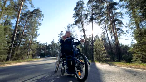 Disabled-man-uses-special-equipment-to-move-on-a-road,-close-up.