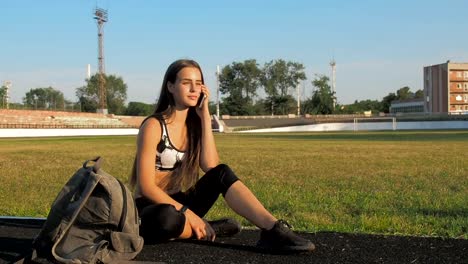 Beautiful-girl-in-sportswear-talking-on-the-phone.