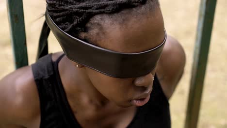 black-african-woman-with-eyes-covered-by-a-black-ribbon.blindness,captivity