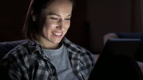 Woman-using-digital-tablet-at-night