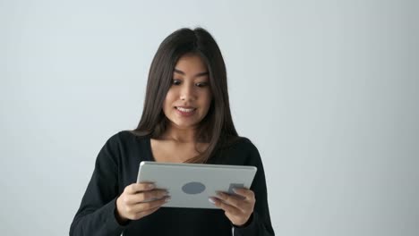 Young-woman-playing-game-on-digital-tablet