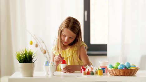 happy-girl-coloring-easter-eggs-at-home