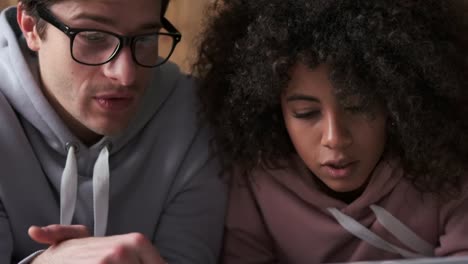 Couple-discussing-and-using-laptop