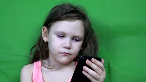 Little-girl-watching-video-on-a-smartphone