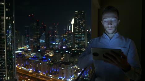 Caucasian-man-using-digital-tablet-for-internet-and-communications-with-cityscape-background