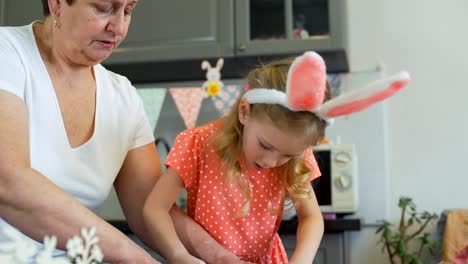 Little-Girl-with-her-Gradma-Rolling-Out-a-Dough