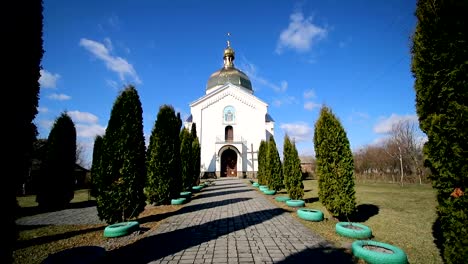 An-old-little-church,-and-next-to-high-tui-that-flutter-from-the-wind