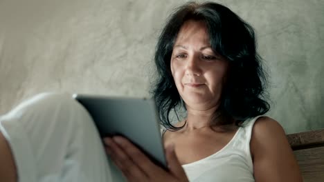 Attractive-woman-using-her-digital-tablet