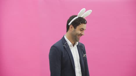 Young-sexy-couple-on-pink-background.-With-hackneyed-ears-on-the-head.-During-this-reproduction-sexual-rabbit-movements-and-looks,-after-a-while-go-out-of-the-frame.