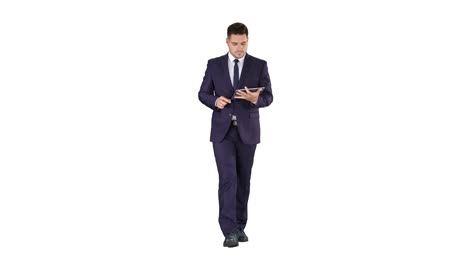 Man-in-suit-walking-and-using-digital-tablet-on-white-background