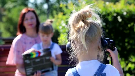 A-little-girl-in-headphones-with-a-camera-shoots-the-plot.