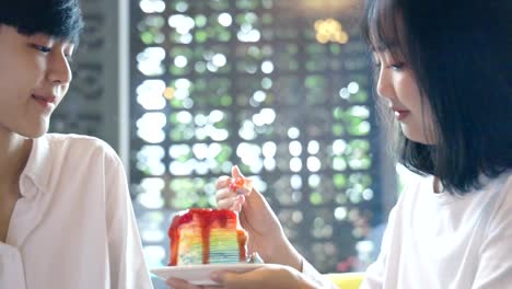 Young-Asian-Lesbian-Couple-Feeding-Sweet-Rainbow-Cake,-LGBT-Love-Moment-Slow-motion