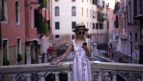 Slow-motion-effect-of-young-cheerful-female-tourist-reading-received-email-with-funny-jokes-from-friend