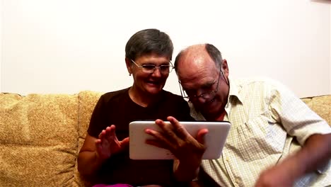 Attractive-adult-woman-and-adult-man-make-a-video-call-with-their-family-on-a-tablet-pc.