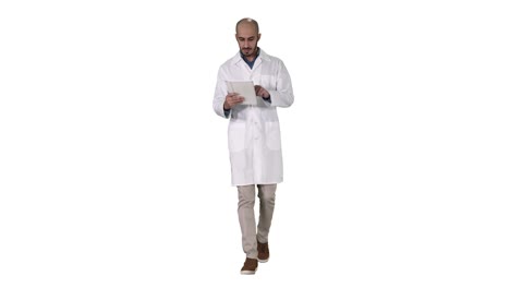 Mature-male-doctor-holding-digital-tablet-using-it-and-walking-on-white-background